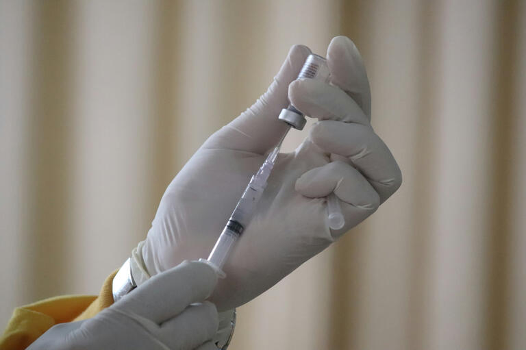 Injecting vaccine into a needle